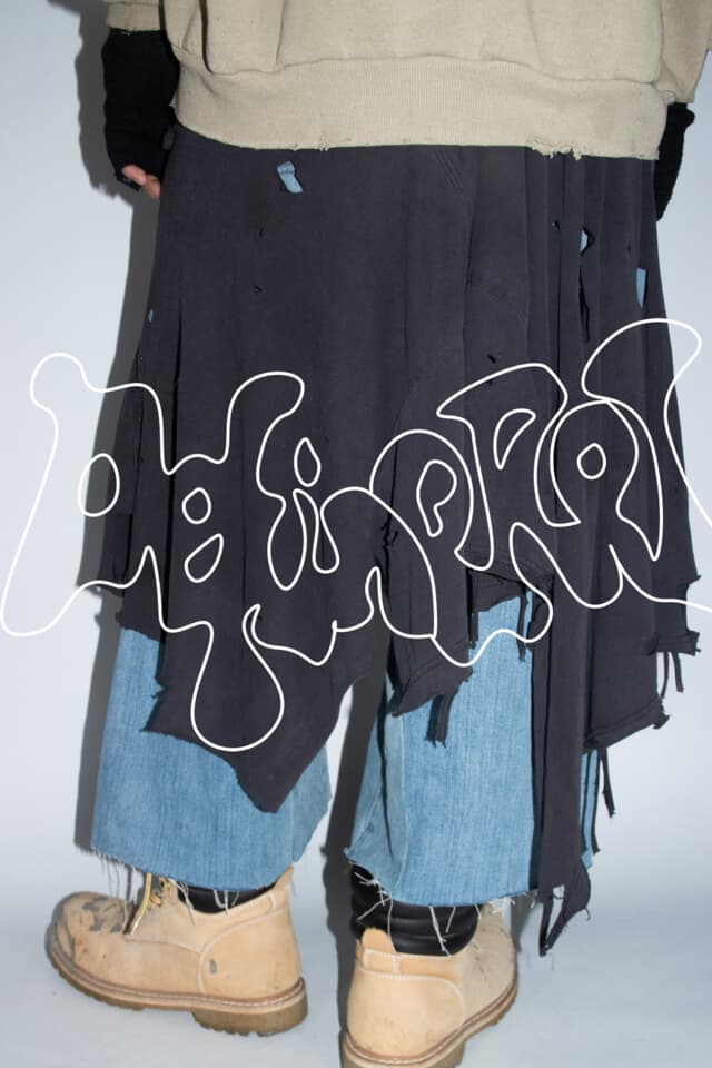 Distressed denim shorts on model, full-length photo